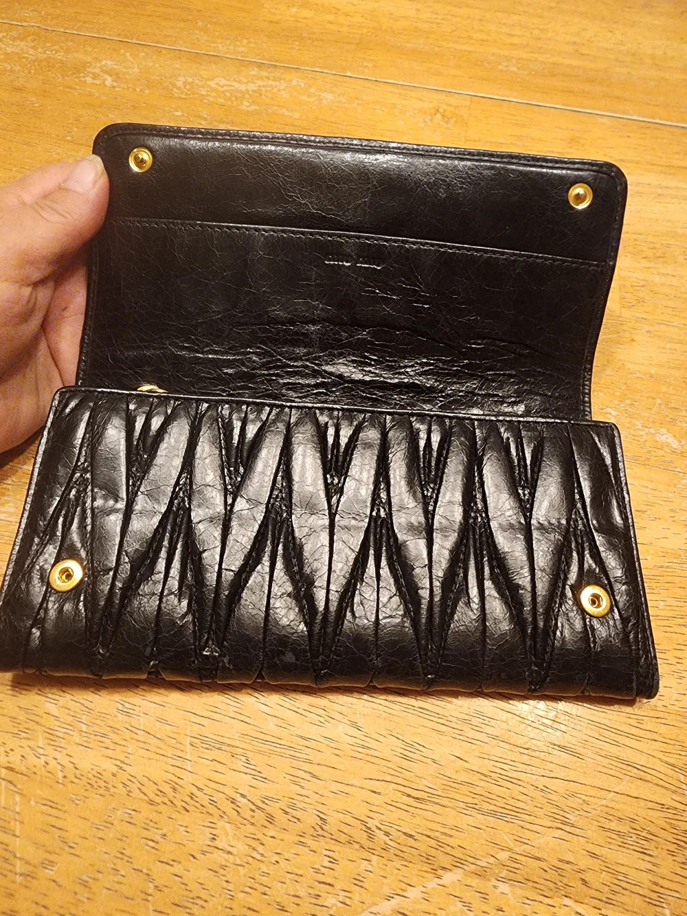 black quilted leather Miu Miu Matelassé long bifold wallet gold-tone Logo